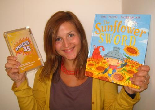 Author Miriam Latimer holding up her gold award and the picture book that won the day